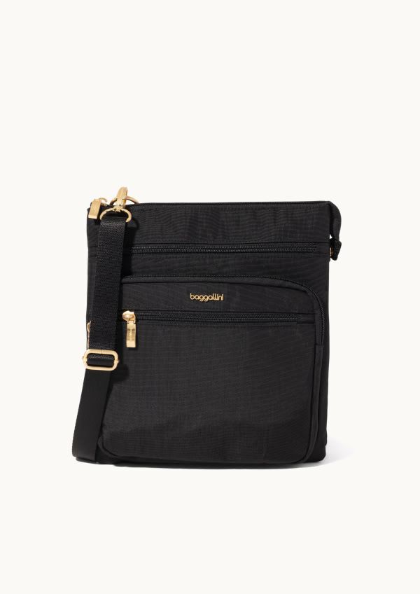 Black crossbody bag with gold-tone zippers and adjustable strap displayed against a light neutral background.