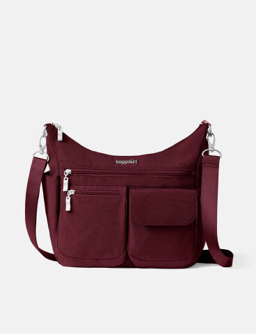 Navy shoulder bag featuring multiple exterior pockets, zippered storage compartments, and an adjustable crossbody strap.