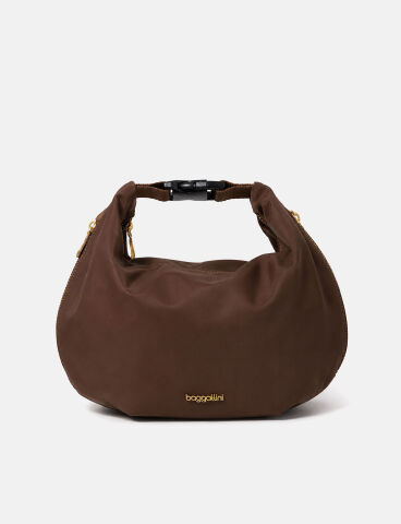 A taupe crossbody bag with adjustable strap, two front zippered pockets, and silver hardware, displayed against a plain white background.