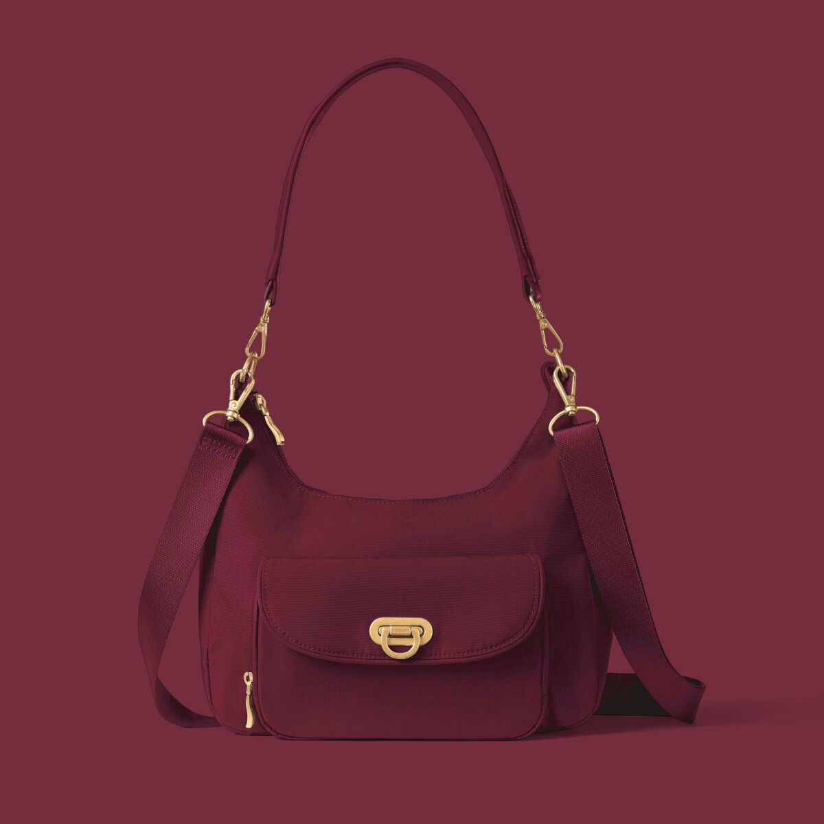 Burgundy Baggallini shoulder bag with removable straps, front pocket and gold hardware.